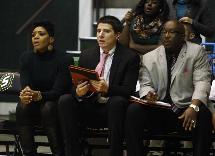 Loyolas new womens basketball assistant Travis Ponton (center).