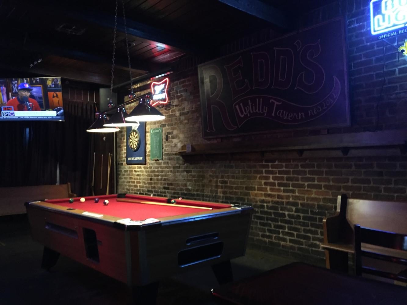 The pool table lays idle within Redds Uptown Tavern. Reids is one of several college hangouts on Maple Street. Photo credit: Caleb Beck