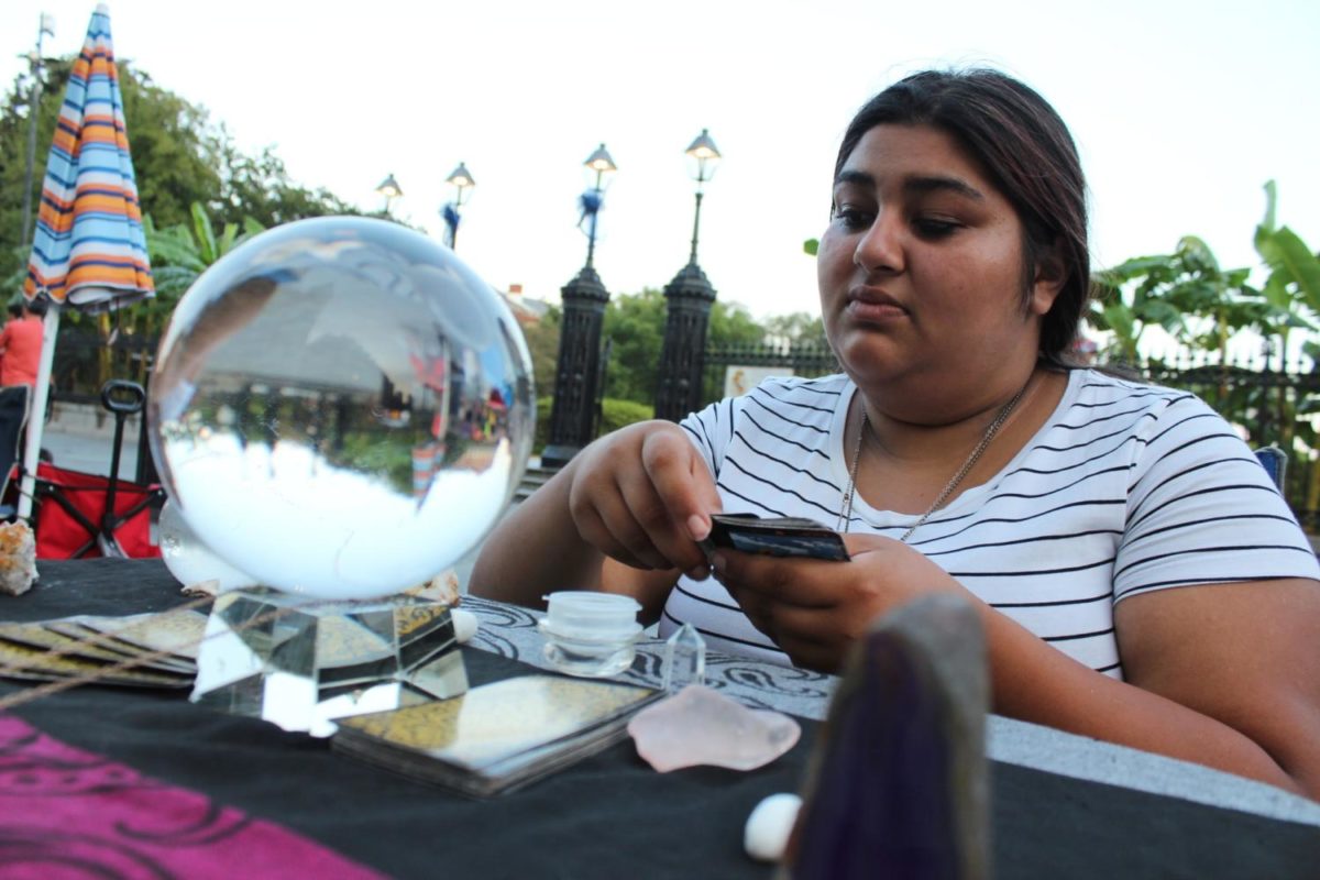 Fortune teller Miss Stephanie deals out tarot cards near her crystal ball Photo credit: Cristian Orellana