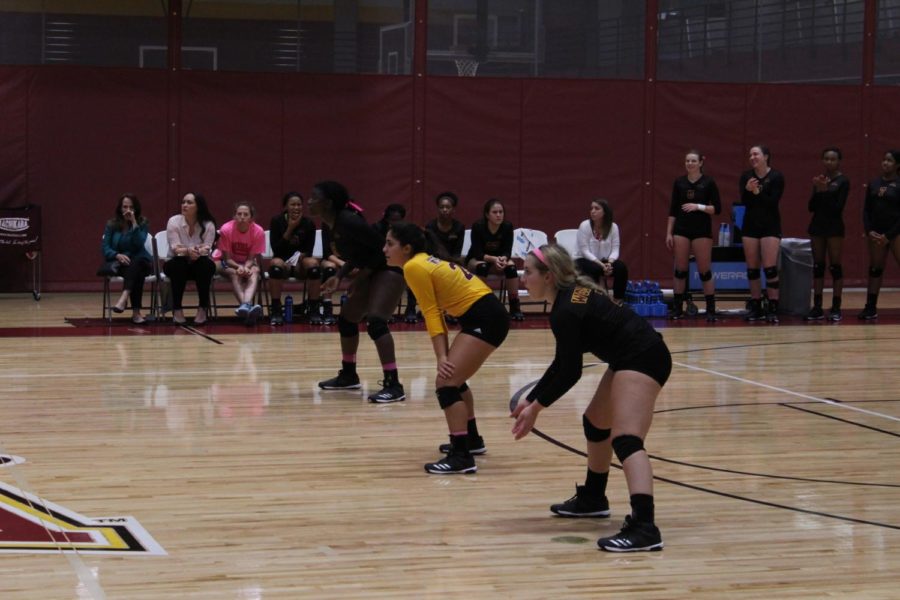 Volleyball players Natavia Mitchell, Kaitlynn Mitchell, and wait to counter a shot. Photo credit: Cristian Orellana