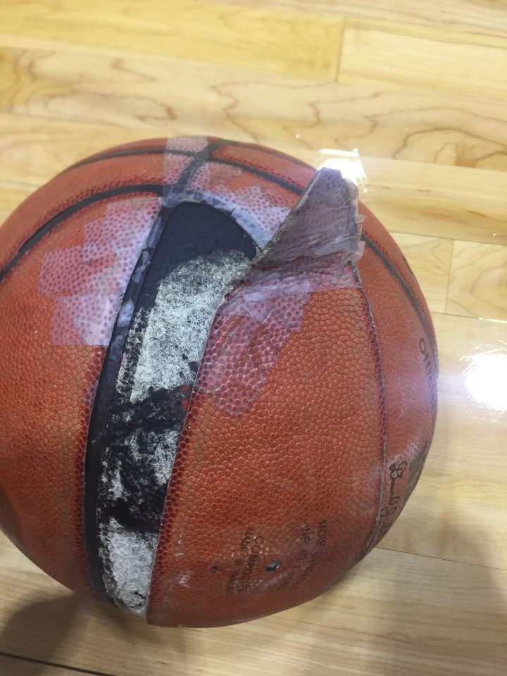 A basketball in the sports complex is held together by tape. Photo credit: Jc Canicosa