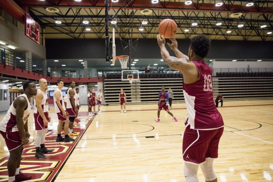 #12 Eric Brown shooting a 3 pointer during a drill. Practice was held in Loyola University Sports Complex. Photo by Jules Santos. Photo credit: Julia Santos