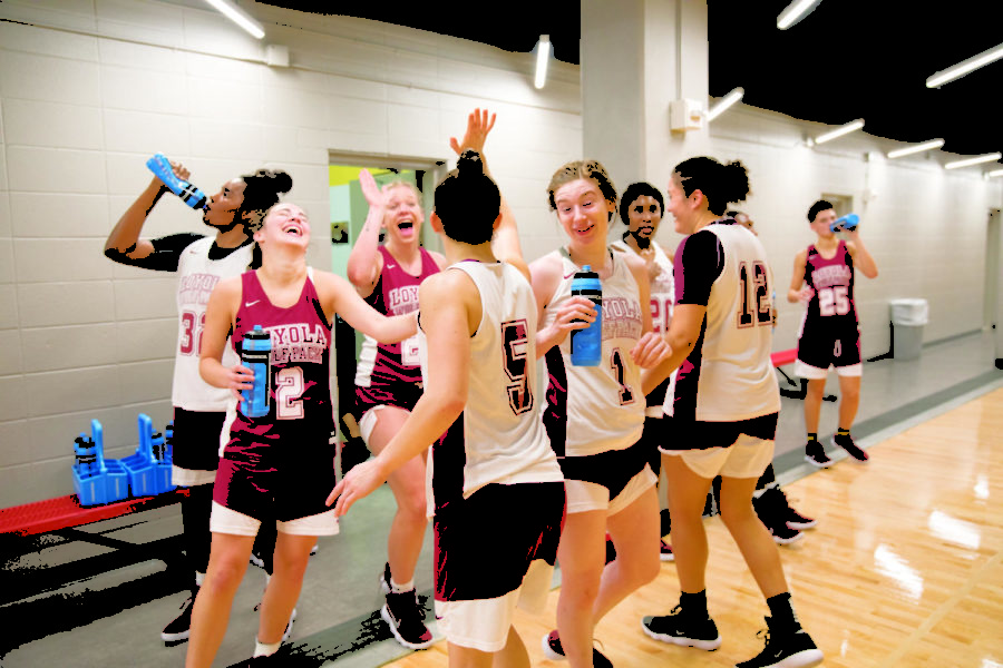 Women's basketball team enjoying a refreshing water break. The practice was held in the Loyola University sports complex on Friday. Photo by Jules Santos. Photo credit: Jules Santos