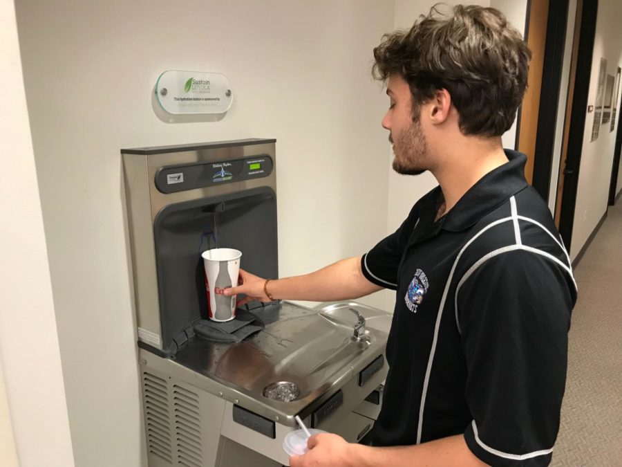 Mass communication junior Nick Boulet uses a water refill station in the Monroe Library.  The stations have eliminated waste from millions of water bottles. Photo credit: John Casey