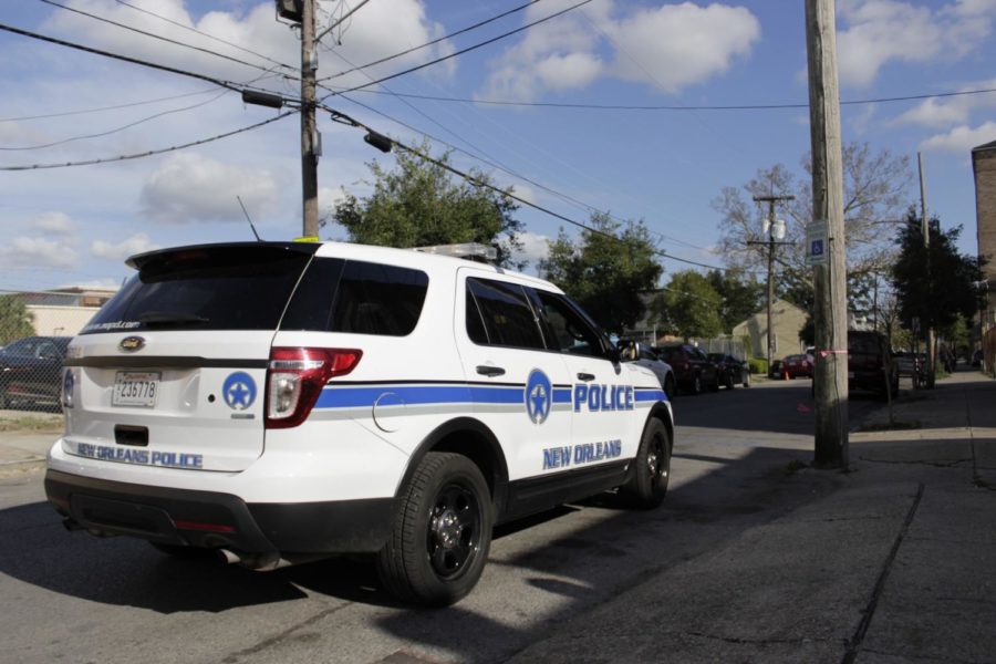 A New Orleans Police Department vehicle sits outside as an officer responds to a call in the Lower Garden District.  Police in the Uptown area are on high-alert as vehicle-related crimes have spiked up in recent months. Photo credit: John Casey