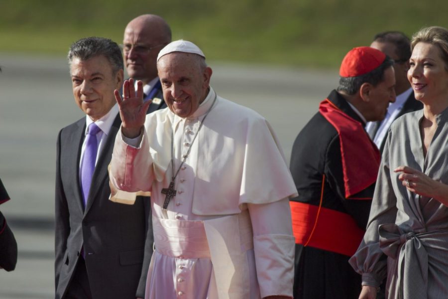 Pope Francis waves next to Colombian President Juan Manuel Santos, left, during his welcoming ceremony upon landing in Bogota, Colombia, on September 6, 2017. (Daniel Garzon Herazo/NurPhoto/Sipa USA/TNS)
