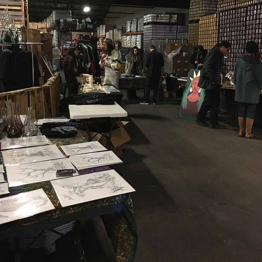 Market goers observe various artwork at Portculture Saturday, Jan. 20th, 2018, at the Urban South Brewery on Tchoupitoulas Street. Several students and young local artists sold their artwork at the event. Photo credit: Kaylie Saidin Photo credit: Kaylie Saidin