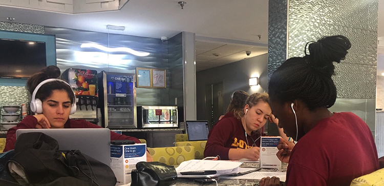 Loyola Volleyball team members work on class assignments Sept. 16, 2017, at Faulkner University in Montgomery, Alabama, before facing 
 the Faulkner Eagles. Photo credit: Jesse Zabal