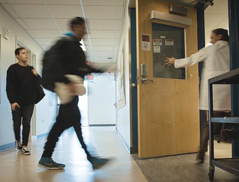 Students Rush to an anatomy and physiology lab Jan. 12, 2018, in Monroe Hall. The 12:30 class had seven students waitlisted that day. It had one of the largest waitlists at the time. Photo by Julia Santos. Photo credit: Julia Santos