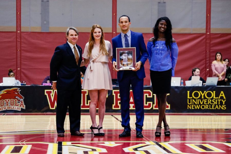 Ryan Brock, escorted by two members of the 2002 womens volleyball team, was inducted into Loyolas hall of fame Jan. 20, 2018 in the Den. Brock averaged 21.1 points per game over three seasons at Loyola. Photo credit: Julia Santos