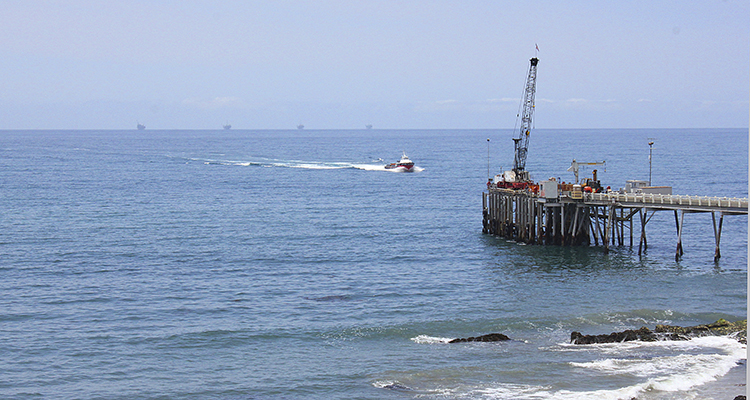 This May 16, 2015 photo shows oil drillings offshore of a service pier in the Santa Barbara Channel off the coast of Southern California near Carpinteria. The surface temperature of the North Atlantic Ocean are climbing at unprecedented rates. (AP Photo/John Antczak)