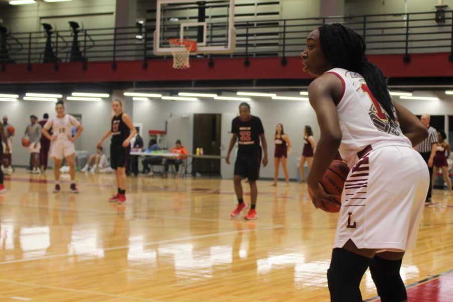 International business sophomore Kaila Anthony (11) looking to send off the inbound pass versus Martin Methodist Feb. 8 2018. Anthony had 15 points in the Wolf Pack win. ANDRES FUENTES/The Maroon.