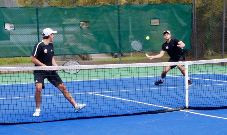 Loyola men's tennis players competing in a doubles match. Both the men's and women's teams went undefeated in their five-game stretch over Spring Break. Photo credit: Loyola University Athletics