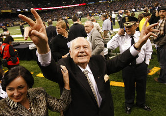 File- This Dec. 19, 2009, file photo shows New Orleans Saints owner Tom Benson walking on the field before the NFL football game against the Dallas Cowboys in New Orleans.  Benson, a successful auto dealer who brought the New Orleans Saints their only winning seasons and the Benson Boogie, has died. Benson, who has also owned the NBA’s New Orleans Pelicans since 2012, was 90. The NFL and NBA teams announced Benson’s death on Thursday,  March 15, 2018. (AP Photo/Dave Martin, File)