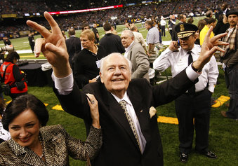 File- This Dec. 19, 2009, file photo shows New Orleans Saints owner Tom Benson walking on the field before the NFL football game against the Dallas Cowboys in New Orleans.  Benson, a successful auto dealer who brought the New Orleans Saints their only winning seasons and the "Benson Boogie," has died. Benson, who has also owned the NBA’s New Orleans Pelicans since 2012, was 90. The NFL and NBA teams announced Benson’s death on Thursday,  March 15, 2018. (AP Photo/Dave Martin, File)