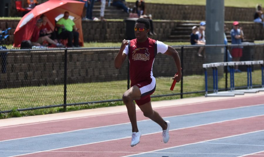 Computer information systems Jarrett Richard competing in a relay at the Southern States Athletic Conference Track and Field Championships on April 21, 2018. The womens team finished in third place overall while the mens team placed in fifth. Photo credit: Loyola University Athletics