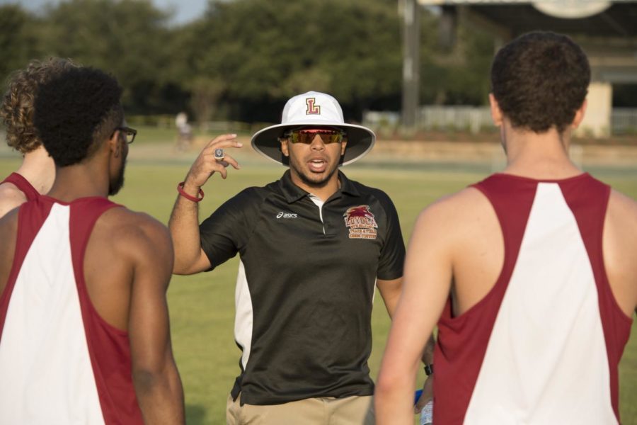 Nick Dodson coaching Loyola track runners at a competition. Dodson will leave Loyola for the head coach position at Southeastern University in Lakeland, Florida after coaching the Wolf Pack for the past two years. Photo credit: Loyola University Athletics