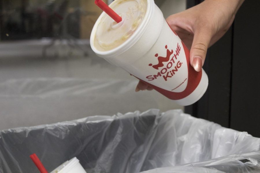 A student throws away a non-recyclable Smoothie King cup in the Communications and Music Complex. Garretty is frustrated with the lack of eco-friendly options at Loyolas Smoothie King. Cristian Orellana // The Maroon Photo credit: Cristian Orellana