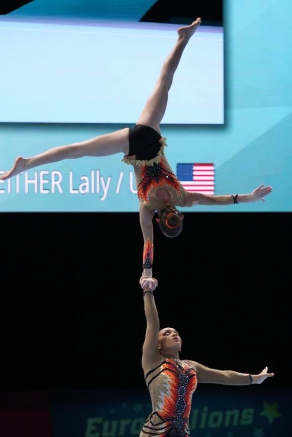 Political science freshman Sam Conway holding her partner Lally Seither in the air. Conway has chosen to leave active competition. Eric Chang/Courtesy.