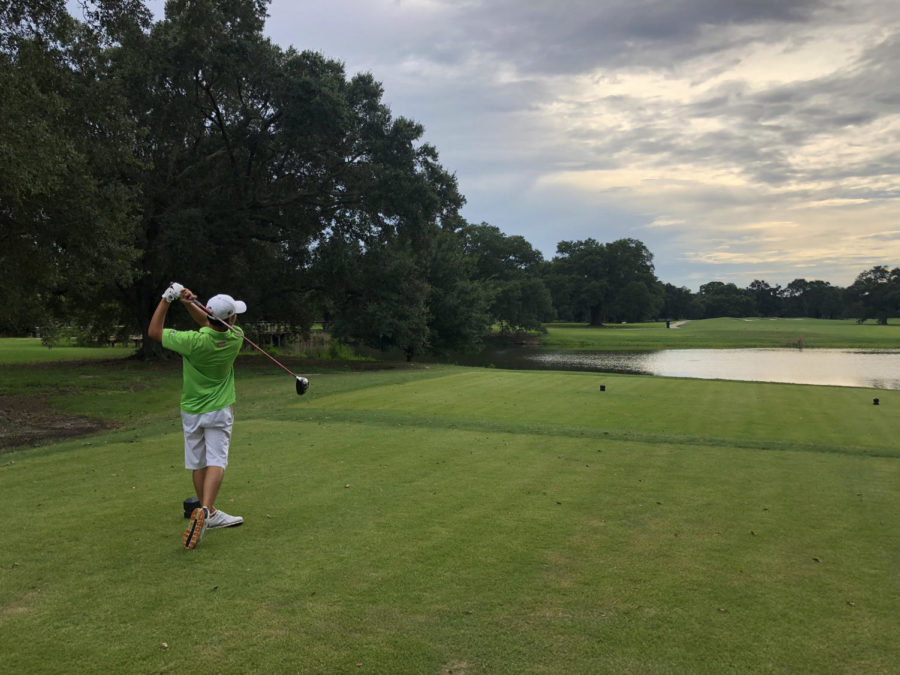 Finance freshman Chong Li Lee tees off at Bayou Oaks City Park. Li is from Johor, Malaysia, but chose Loyola  and joined the golf team. Photo credit: Drew Goff