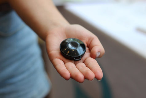 A student holds the POM at Peace of Mind Company’s table in the Danna Center during Wolf Pack Welcome. The POM is a key fob security device designed to put students in touch with emergency responders. Photo credit: Cristian Orellana