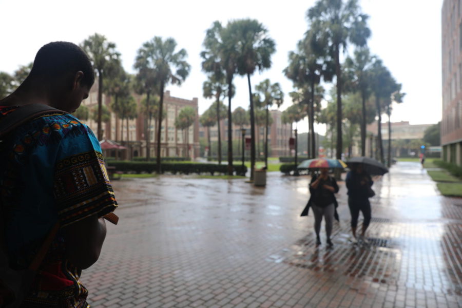 Loyola students try to avoid a sudden rain shower on Aug. 30, 2018. Loyola is currently changing its policy for hurricane preparedness to require campus evacuations during Category Two hurricanes.