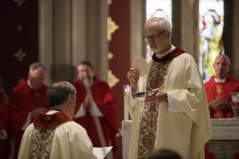 The Rev. Francis Huete, S.J., administers finals vows to The Rev. Gregory Waldrop, S.J., during the Mass of The Holy Spirit on Sept. 6, 2018. Final vows allow for a Jesuit to officially enter the Society of Jesus. Photo credit: Cristian Orellana