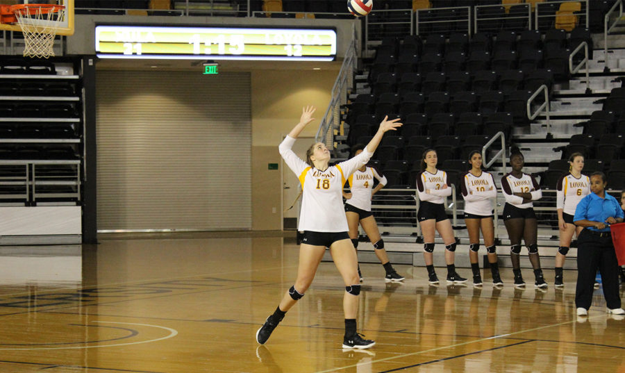 Psychology senior Malea Howie goes to serve the ball. Howie finished with one service ace against Middle Georgia State University. Photo credit: Loyola New Orleans Athletics