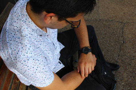 Cameron Kelley, business analytics junior, looks at his watch in the afternoon after class. Kelley is upset that his major requires two accounting classes. VANESSA ALVARADO/The Maroon. Photo credit: Vanessa Alvarado