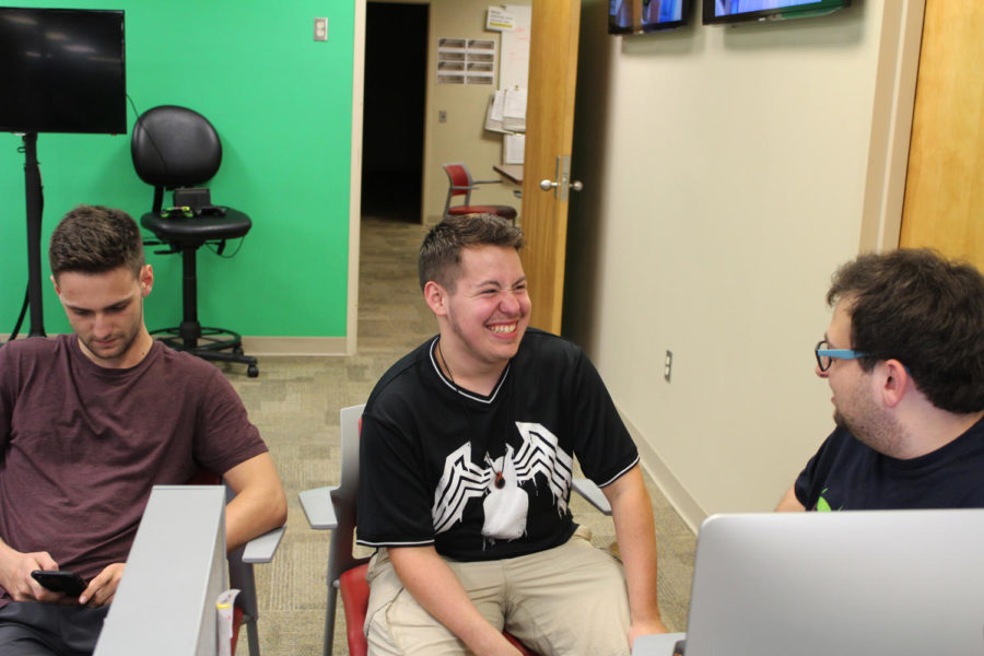 Cody Downey, mass communication junior and copy editor for The Maroon, laughing with his fellow copy editor, Riley Katz. Cody writes about his experiences growing up with two cultures. Photo credit: Andres Fuentes