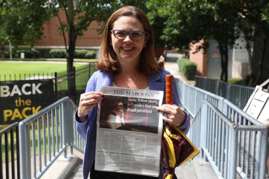 Loyola's 17th president Tania Tetlow holds issue of The Maroon marking her presidential history in 2018. Tetlow was the university's first female layperson president. 