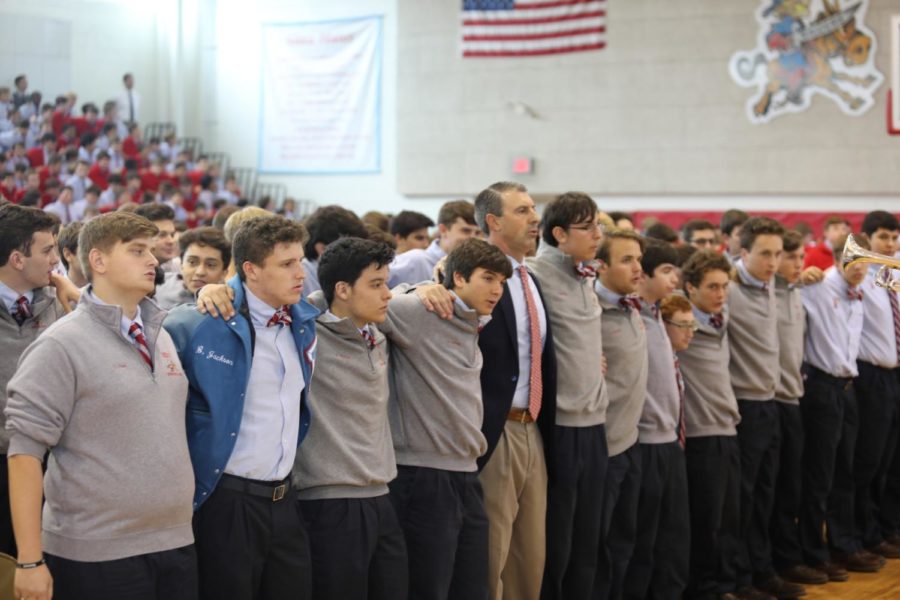 Seniors at Archbishop Rummel High School and Principal Marc Milano sing the alma mater after mass on September 11. Rummel students sing the alma mater after every mass and school event. ANDRES FUENTES/The Maroon. Photo credit: Andres Fuentes