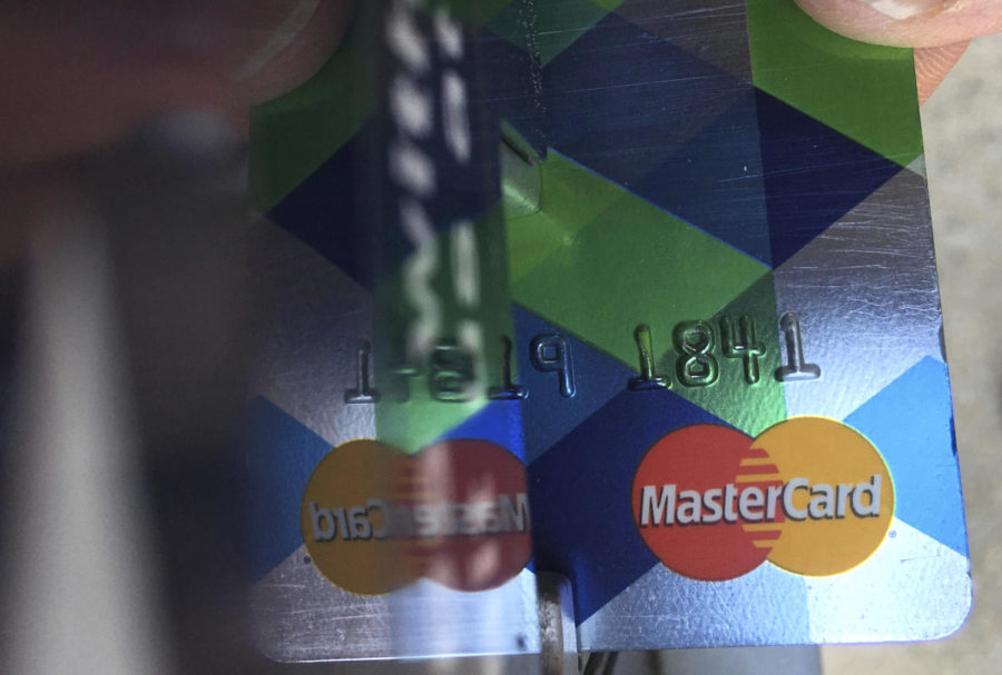 FILE - In this June 15, 2017, file photo, a customer inserts a Mastercard credit card to pay for parking in Haverhill, Mass. Mastercard rolled out a digital trade platform Wednesday, Sept. 12, 2018, designed to make it easier for companies to do business around the world. (AP Photo/Elise Amendola, File)