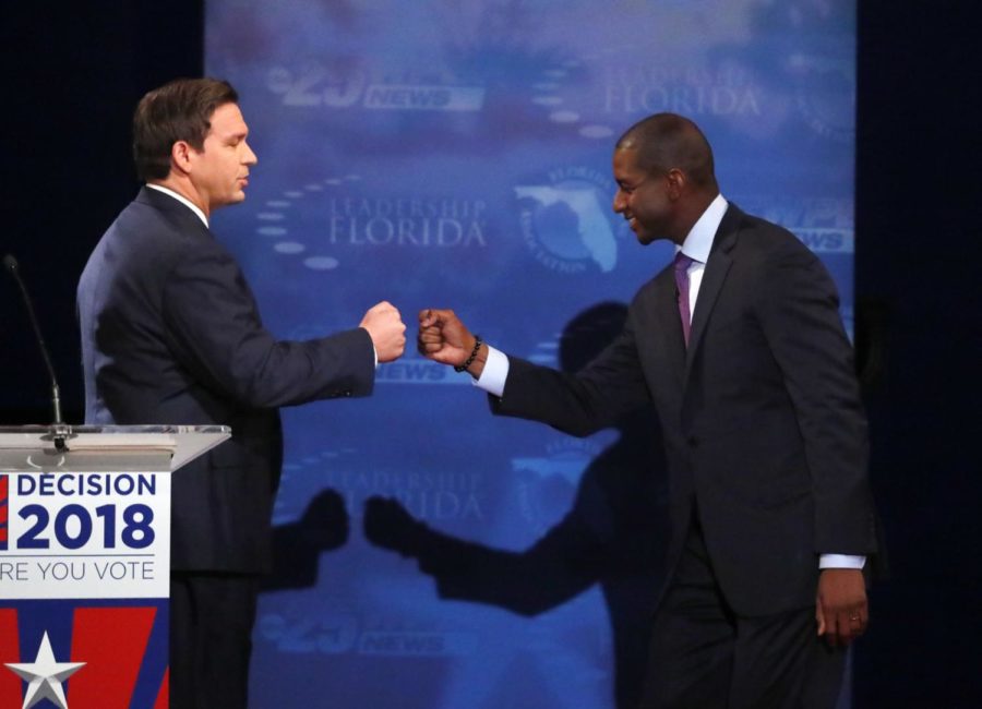 IN this Oct. 24, 2018, photo, Florida gubernatorial candidates, Republican Ron DeSantis, left, and Democrat Andrew Gillum fist bump after a debate at Broward College in Davie, Fla. The final stretch of the midterm campaign is increasingly dominated by debate over one of the most sensitive issues in American political culture: Race. In Florida, accusations of racism are playing a central role in the hotly-contested campaign for governor. DeSantis chafed at questions about his ties to supporters who have made inflammatory comments. (AP Photo/Wilfredo Lee, Pool)