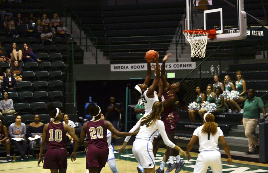 Loyola goes for a block. The Wolf Pack finished with eight blocks in the game. Photo credit: Andrew Lang