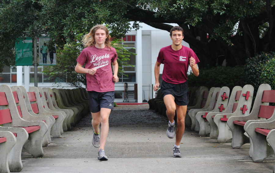 Environmental studies sophomore Walter Ramsey  (left) and pyschology sophomore Hayden Ricca (right) run in the peace quad. Ricca and Ramsey both qualified for the National Association for Intercollegiate Athletics Cross Country National Championships. Photo credit: Cristian Orellana