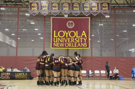 The Loyola's volleyball team huddles together at a home game. Photo credit: Cristian Orellana