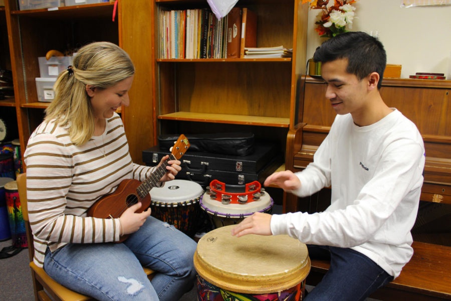 Music therapy seniors Katarina Prasso (left) and Calvin Tran (right) practice playing instruments Wednesday in the department's music lab. Music therapy majors are required to proficiently play a variety of instruments used in therapeutic sessions. Photo credit: India Yarborough