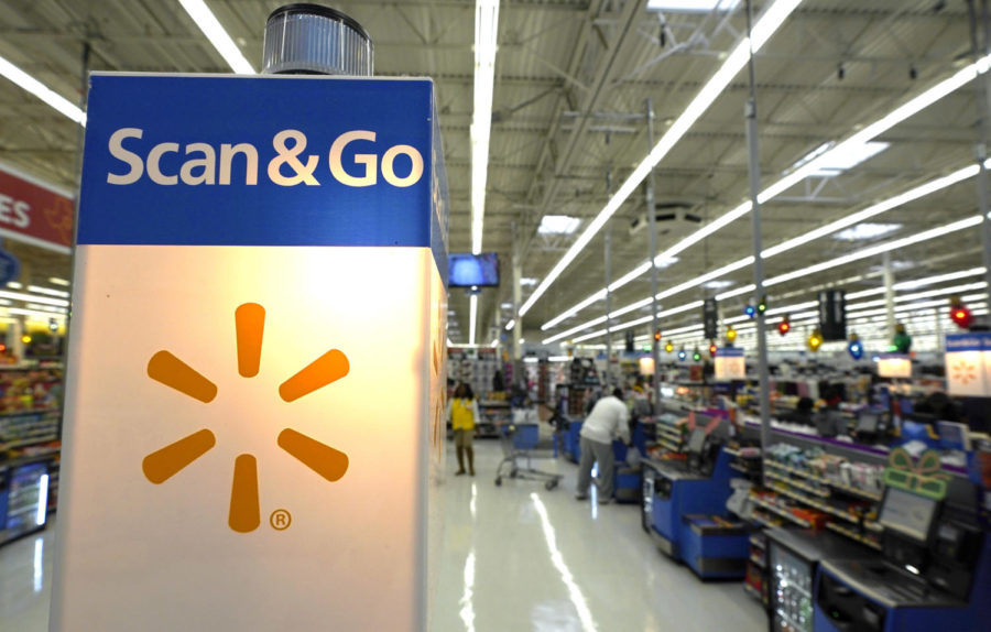 This Nov. 9, 2018, photo shows a Scan & Go checkout area at a Walmart Supercenter in Houston.  Retailers will once again offer big deals and early hours to lure shoppers into their stores for the start of the holiday season. But they'll also try to get shoppers out of their stores faster than ever by minimizing the thing they hate most: long lines. (AP Photo/David J. Phillip)