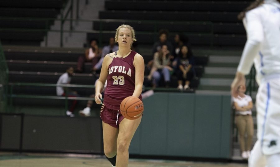Psychology senior Megan Worry (23) racked up her 100th career block and her eighth double-double of the season. Photo credit: Loyola New Orleans Athletics