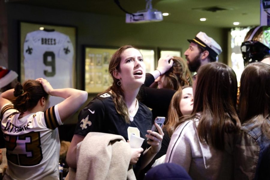 Saints fans are stunned after the Rams gain possession in overtime.