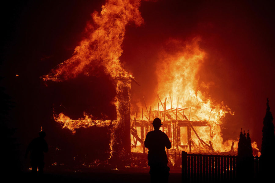 FILE - In this Nov. 8, 2018, file photo, a home burns as the Camp Fire rages through Paradise, Calif. California wildland managers announced a plan to speed up logging and prescribed burns designed to protect communities from wildfires, at a news conference Tuesday, Jan. 29, 2019. The effort would create a single environmental review process to cover vegetation reduction projects, field breaks and restoration projects. (AP Photo/Noah Berger, File)