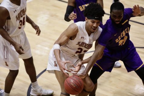 Mass communication freshman Zach Wrightsil (23) has the ball stolen by a Bethel University player. Photo credit: Michael Bauer