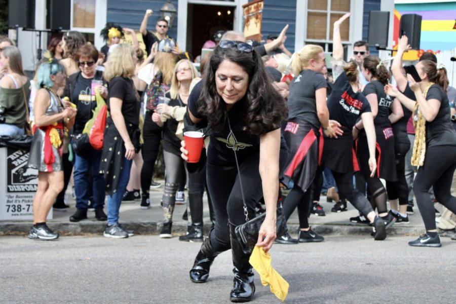 A Saints fan picks up a thrown flag at the Magazine Street block party. Photo credit: Madison Mcloughlin