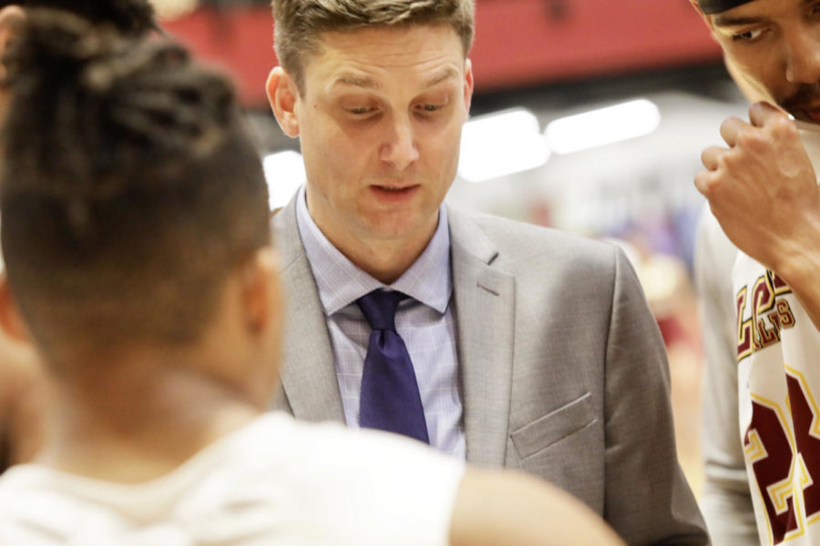 Men’s head basketball coach Stacy Hollowell reviews the game plan before playing Bethel University on Feb. 14. Photo credit: Andres Fuentes