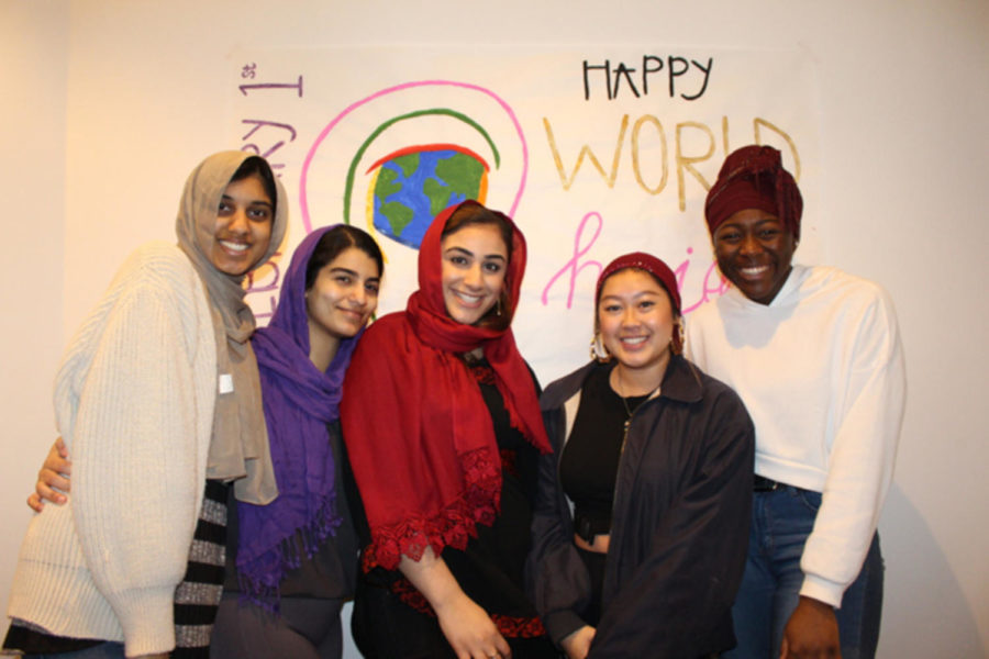 A group of Loyola students tries on hijabs during the Muslim Students Association’s celebration of World Hijab day on Feb. 1.  The organization hosted the event in order to combat stereotypes about people who wear hijabs. Photo credit: Ruba Esmail