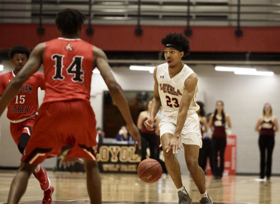 Mass communication freshman Zach Wrightsil dribbles past William Carey defenders. Wrightsil has won Player of the Month, the first Loyola athlete since 2012. Photo credit: Andres Fuentes