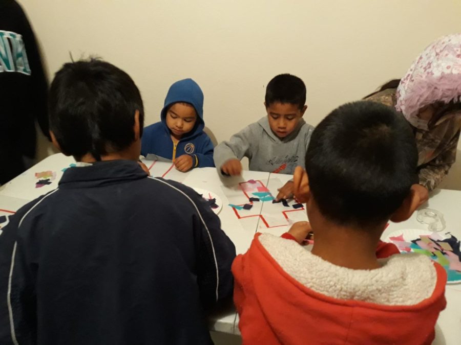 A group of children make a suncatcher cross. The cross was meant to represent how Jesus is the light of the world. Photo credit: Cody Downey