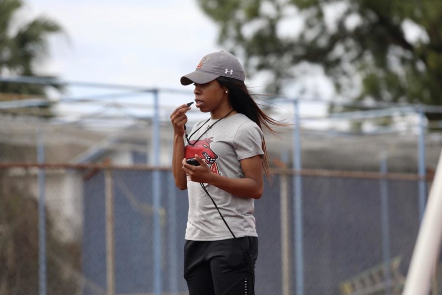 Track and field assistant coach Amani Bryant leads practice at East Jefferson High School. In their first meet of the season, Loyola marked multiple personal records. Photo credit: Andres Fuentes