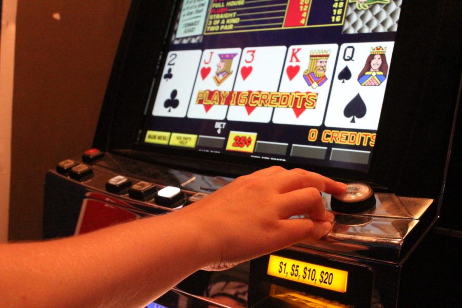 A customer uses one of the slot machines at Bruno's Tavern in Uptown New Orleans. Bars and casinos across the city have slot machines allowing visitors to gamble. Photo credit: India Yarborough